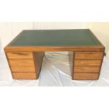CARSONS TEAK PARTNERS DESK with an inset green leather top above an arrangement of seven drawers