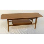 TEAK OCCASIONAL TABLE with an oblong top standing on turned supports united by an undertier, 121cm