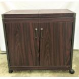 WOOD EFFECT HOSTESS TROLLEY with a pull apart top above a pair of cupboard doors opening to reveal