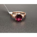 CERTIFIED GARNET AND DIAMOND RING the central oval cut Rajasthan garnet weighing 2.21cts flanked