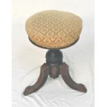 VICTORIAN WALNUT PIANO STOOL with a circular adjustable stuffover seat on a turned column with three