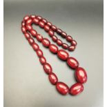 GRADUATED CHERRY AMBER COLOURED BEAD NECKLACE 40 grams and approximately 53cm long