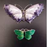 TWO ENAMEL DECORATED SILVER BUTTERFLY BROOCHES the larger in light and dark purple, 6.2cm wide;