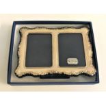 SILVER DOUBLE PHOTOGRAPH FRAME with embossed floral decoration to the shaped edges, on easel
