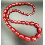 GRADUATED CHERRY AMBER COLOURED BEAD NECKLACE approximately 85cm long and 124 grams