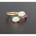 OPAL TWIST DESIGN RING the two oval cabochon opals on nine carat gold shank, ring size N