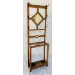 ARTS AND CRAFTS LIGHT OAK HALL STAND with a central diamond shaped mirror flanked by six shaped