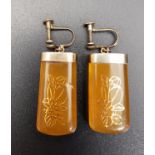 PAIR OF GOLD DECORATED AMBER COULOURED DROP EARRINGS the gold forming floral designs, in silver
