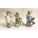 THREE LLADRO FIGURINES comprising the jester, 20cm high, two girls and a kitten, 17.5cm high and