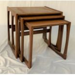 G PLAN NEST OF TEAK TABLES on shaped supports, 49cm high