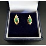 PAIR OF EMERALD AND DIAMOND STUD EARRINGS the marquise emeralds and round cut diamonds in shaped