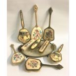 DRESSING TABLE SET comprising a shaped tray, two hair brushes and a hand mirror in gilt brass with
