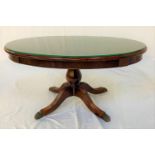 MAHOGANY AND CROSSBANDED OCCASIONAL TABLE with an oval top on a turned column with four outswept