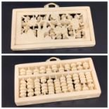 CHINESE CARVED IVORY ABACUS of rectangular form with fold over handle above carved circular