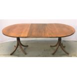 OAK D END DINING TABLE with an extra leaf, raised on twin turned columns, each with four outswept