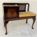 MAHOGANY AND CROSSBANDED TELEPHONE TABLE with a part caned back and cushion seat, with a cupboard