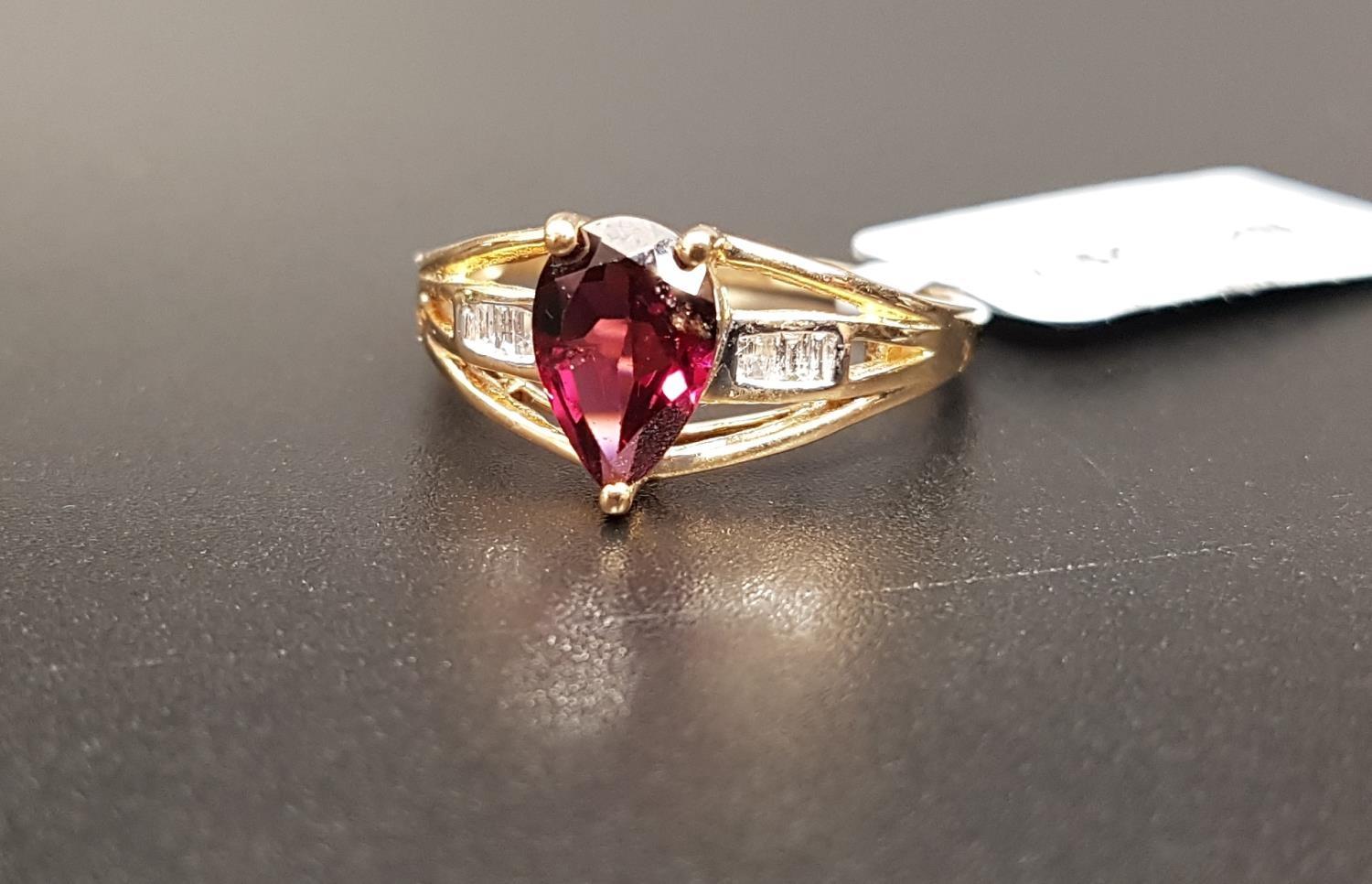 CERTIFIED GARNET AND DIAMOND RING the central pear cut Rajasthan garnet weighing 1.62cts, flanked by