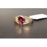 CERTIFIED GARNET AND DIAMOND RING the central pear cut Rajasthan garnet weighing 1.62cts, flanked by