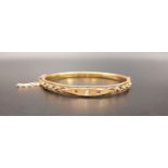 EDWARDIAN DIAMOND AND RUBY FIFTEEN CARAT GOLD BANGLE the central flush set diamond approximately 0.