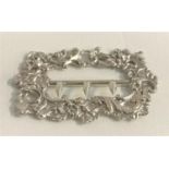 VICTORIAN SILVER BUCKLE with profuse embossed floral and scroll decoration, hallmarked for 1888,