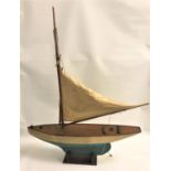 VINTAGE POND YACHT of wooden construction with two sails and a stand, 77cm long