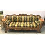 BIEDERMEIER SATIN WOOD SOFA with a shaped carved back above shaped arms, with a padded back and