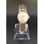 LADIES 1960s OMEGA NINE CARAT GOLD CASED WRISTWATCH the champagne dial with five minute baton