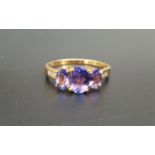 GRADUATED TANZANITE AND DIAMOND RING the central tanzanite approximately 1ct with a further
