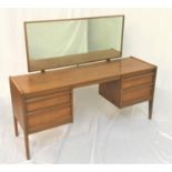 YOUNGER TEAK KNEEHOLE DRESSING TABLE with an oblong mirror above two pairs of drawers, standing on