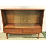 TEAK SIDE CABINET the pair of glass sliding doors with an adjustable shelf above two short