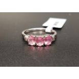 CERTIFIED PINK SPINEL AND DIAMOND RING the three oval cut pink spinels totaling 1.07cts, flanked