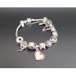 PANDORA MOMENTS SILVER CHARM BRACELET with a good selection of eleven charms including gem set