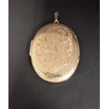 LARGE NINE CARAT GOLD LOCKET PENDANT the oval locket with engraved scroll decoration, 5cm high