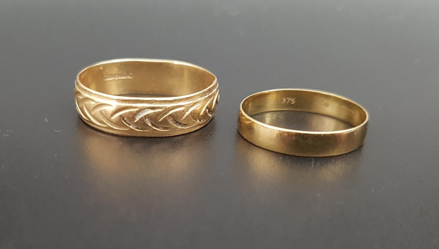 TWO NINE CARAT GOLD WEDDING BANDS the larger example with engraved decoration, ring sizes T and N,