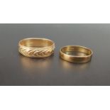 TWO NINE CARAT GOLD WEDDING BANDS the larger example with engraved decoration, ring sizes T and N,