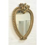 GILTWOOD HEART SHAPED WALL MIRROR surmounted by three putti above a heart shaped plate, 60cm high