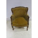 A CONTINENTAL STAINED WOOD AND PARCEL GILT ARMCHAIR the shaped top rail with foliate carving above