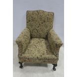 A MAHOGANY AND UPHOLSTERED ARM CHAIR the shaped back with scroll over arms on cabriole legs with