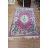 A WOOL RUG, the light pink and beige ground with overall floral decoration 193cm (l) x 25cm (w) .