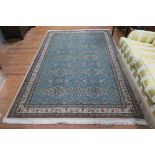 A TURKISH RUG the turquoise ground with overall floral sprays within a conforming border 300cm x