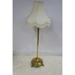 A 19TH CENTURY BRASS STANDARD LAMP the octagonal column above a circular spreading foot with