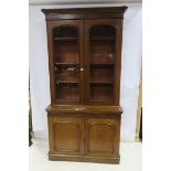 A 19TH CENTURY MAHOGANY LIBRARY BOOKCASE the moulded cornice above a pair of glazed doors