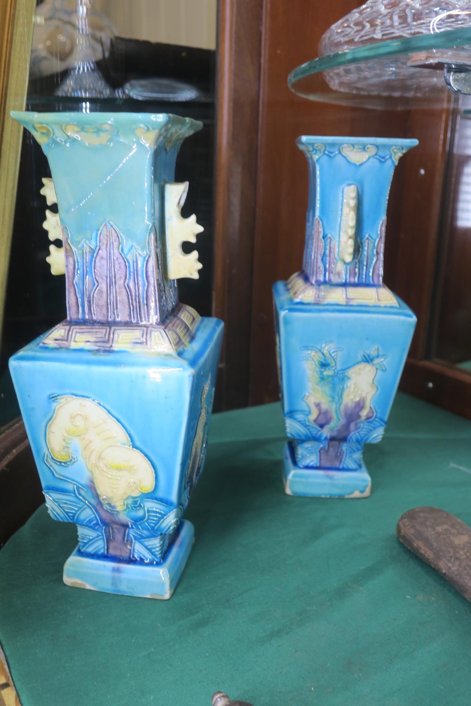 A PAIR OF ORIENTAL GLAZED POTTERY VASES the turquoise and light green ground decorated with dogs of