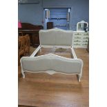 A CONTINENTAL CREAM PAINTED UPHOLSTERED BED the shaped top rail with upholstered panel on cabriole