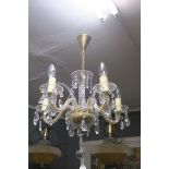 A CONTINENTAL CUT GLASS FIVE BRANCH CHANDELIER hung with pendent drops