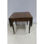 A REGENCY MAHOGANY DROP LEAF TABLE the rectangular hinged top above a frieze drawer on fluted and