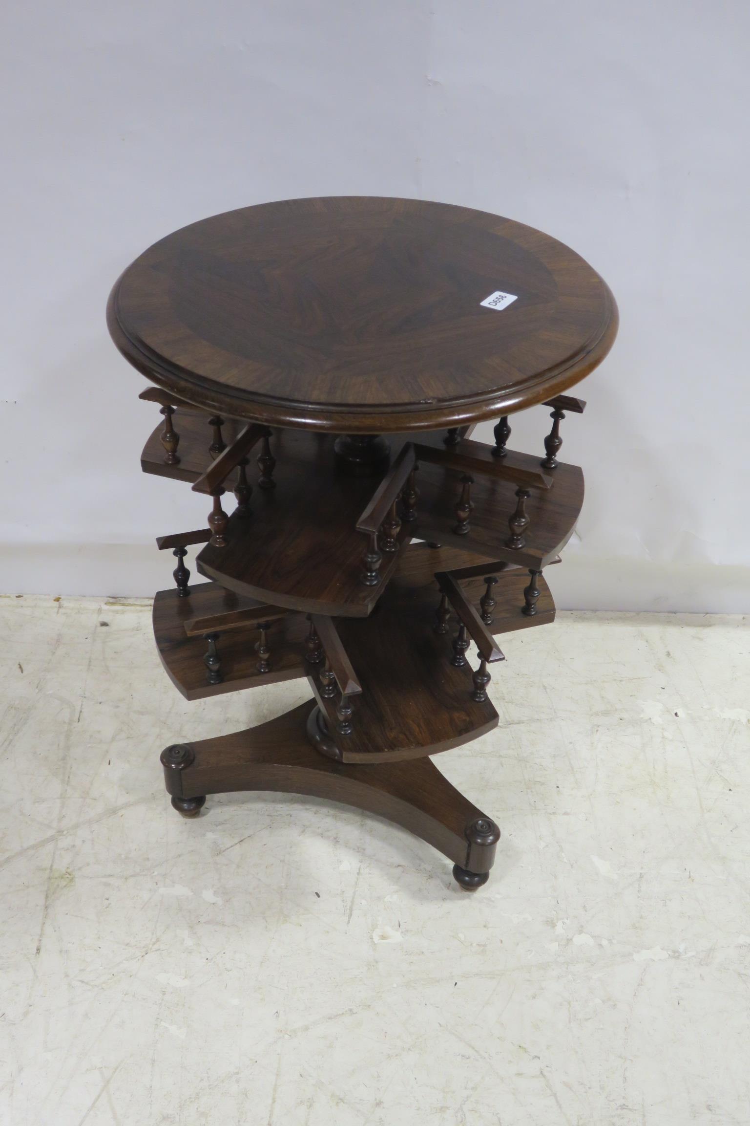 A 19TH CENTURY ROSEWOOD OCCASIONAL TABLE the circular cross banded top above a two tier revolving