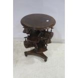 A 19TH CENTURY ROSEWOOD OCCASIONAL TABLE the circular cross banded top above a two tier revolving