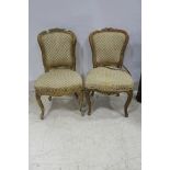 TWO 19TH CENTURY CARVED GILTWOOD AND UPHOLSTERED SIDE CHAIRS each with an oval upholstered back and