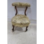 A 19TH CENTURY MAHOGANY AND UPHOLSTERED NURSING CHAIR the curved upholstered top rail above an